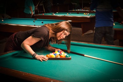 Picture of a woman setting up a game of pool